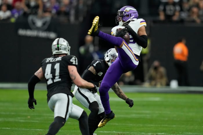 Minnesota Vikings wide receiver Justin Jefferson makes a catch as Las Vegas Raiders safety Marcus Epps (1) defends during the first half in Las Vegas. (AP Photo/John Locher)